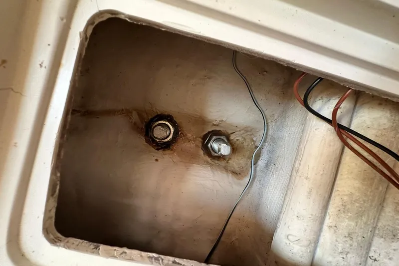 Slide: The Image of Bilge compartment of 2008 Catalina 320 sailboat with visible wiring and bolts. - 55
