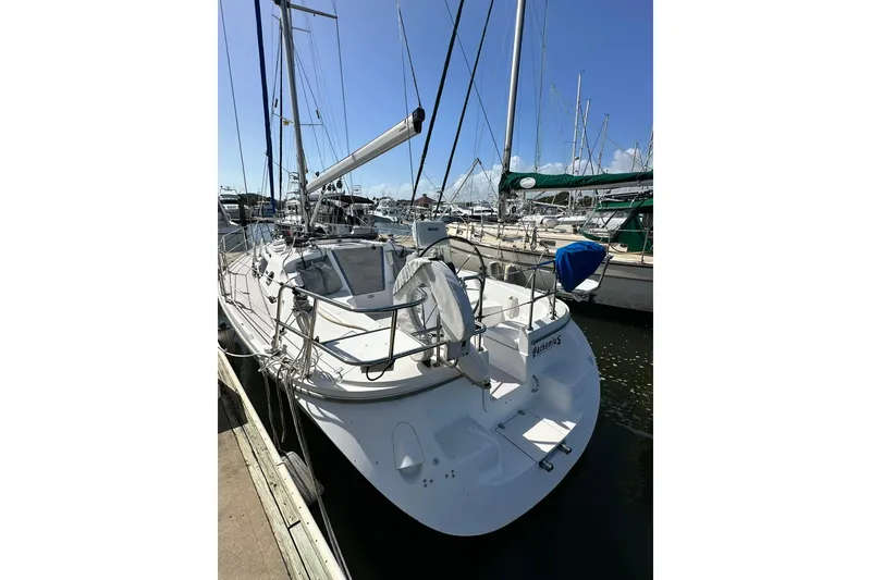 Slide: The Image of 2008 Catalina 320 sailboat docked at marina under clear blue sky. - 6