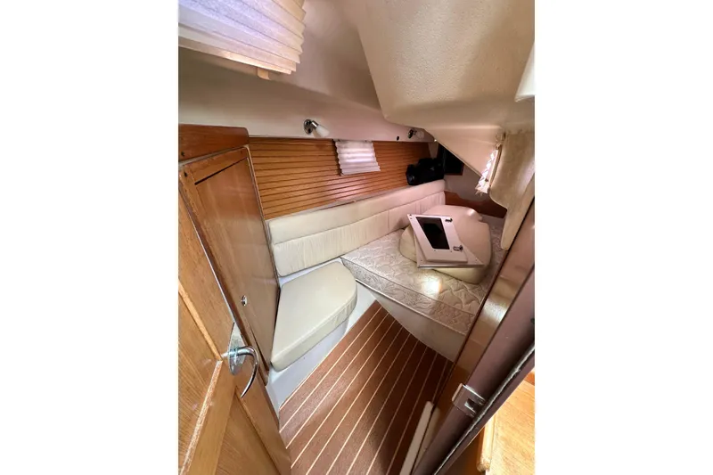 Slide: The Image of Interior cabin of 2008 Catalina 320 sailboat with cozy seating and wooden accents. - 65