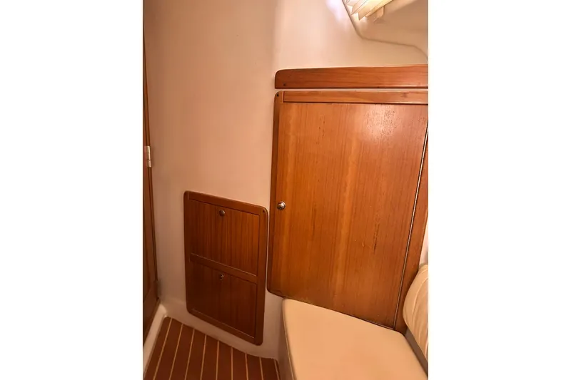 Slide: The Image of Interior of 2008 Catalina 320 sailboat with wooden cabinetry and seating. - 67