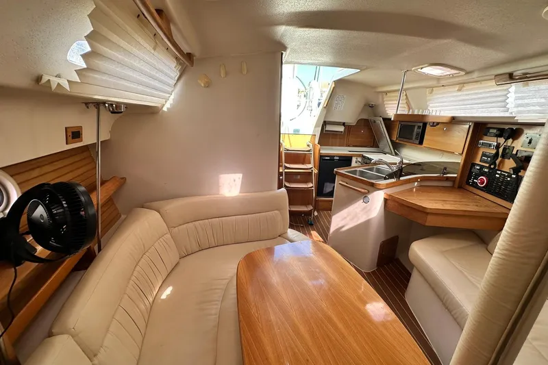 Slide: The Image of Interior of a 2008 Catalina 320 sailboat with cozy seating and modern kitchen amenities. - 69
