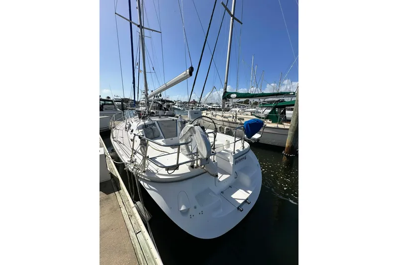 Slide: The Image of 2008 Catalina 320 sailboat docked at marina under clear blue sky. - 7