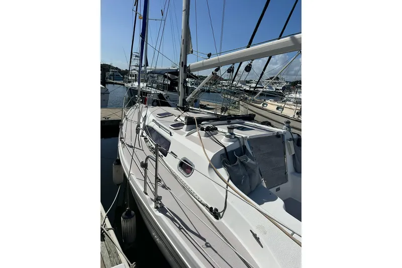 Slide: The Image of 2008 Catalina 320 sailboat docked at marina under clear blue sky. - 8