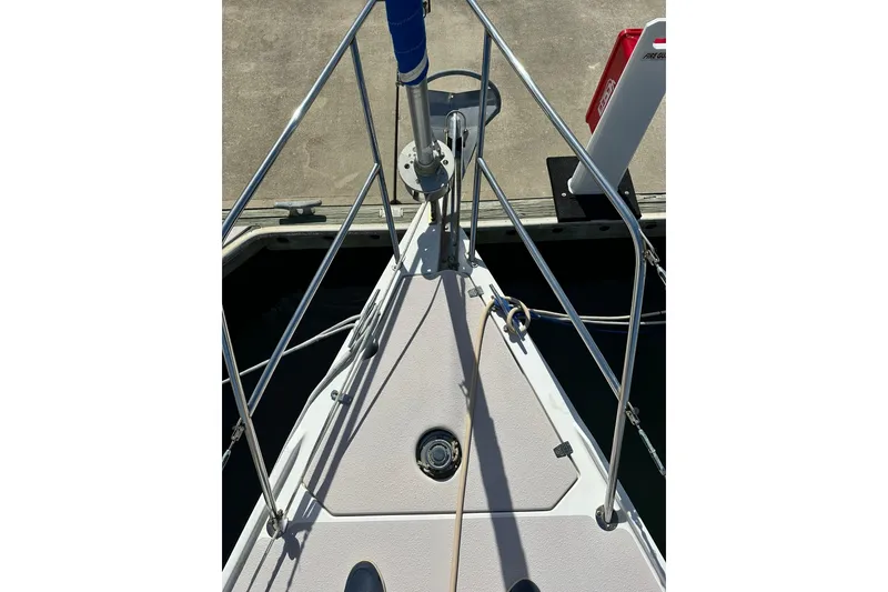 Slide: The Image of Bow of 2008 Catalina 320 sailboat docked, featuring stainless steel railings and deck fittings. - 9