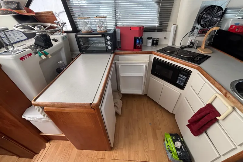 Slide: The Image of Interior of a 1993 Carver 350 Voyager with kitchen, TV, and pet area. - 11