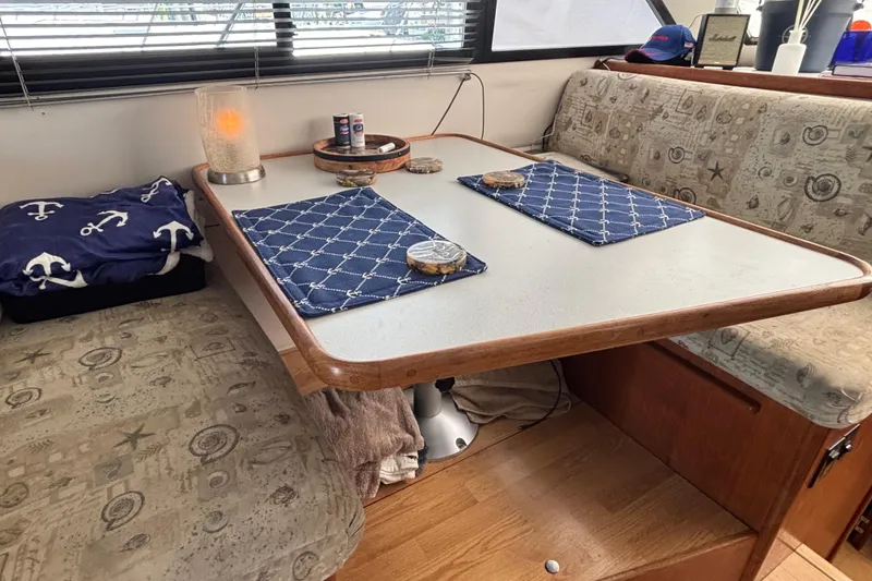 Slide: The Image of 1993 Carver 350 Voyager yacht kitchen with appliances, steering wheel, and wooden flooring. - 14