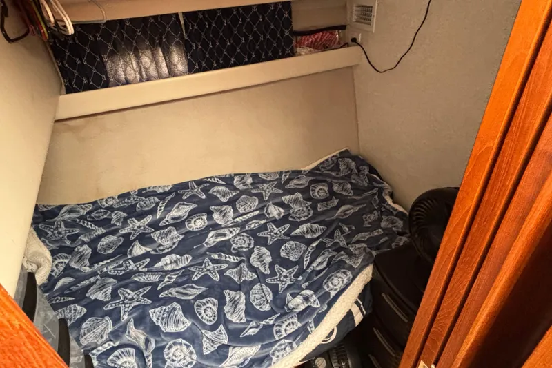 Slide: The Image of Interior of 1993 Carver 350 Voyager with colorful quilt and wooden cabinetry. - 23