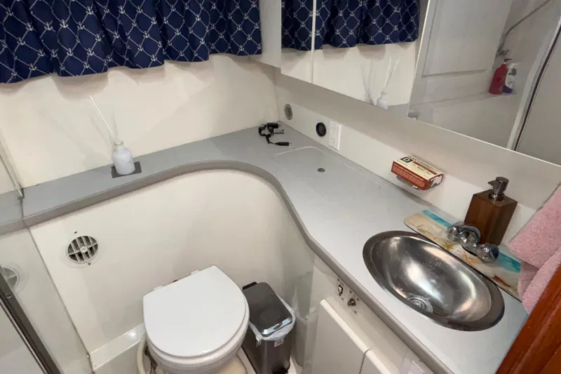 Slide: The Image of 1993 Carver 350 Voyager cabin interior with nautical-themed bedding. - 24