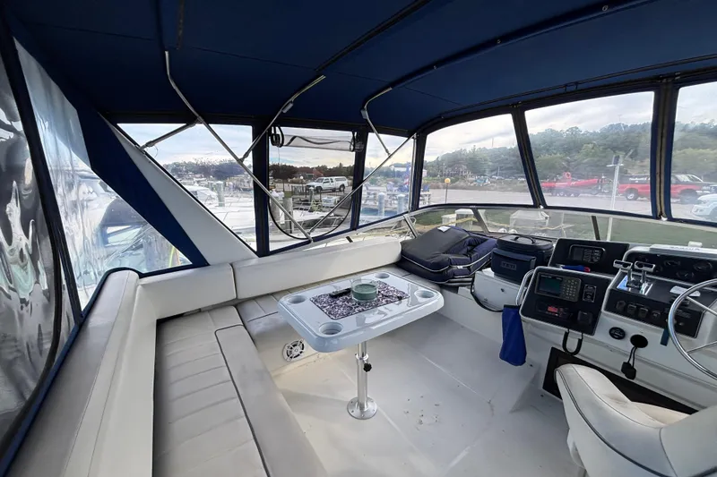 Slide: The Image of Interior of 1993 Carver 350 Voyager with fridge, pet bed, and nautical decor. - 28