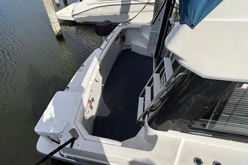 Slide: The Image of Nautical-themed bedroom in 1993 Carver 350 Voyager with colorful quilt and decorative pillows. - 3