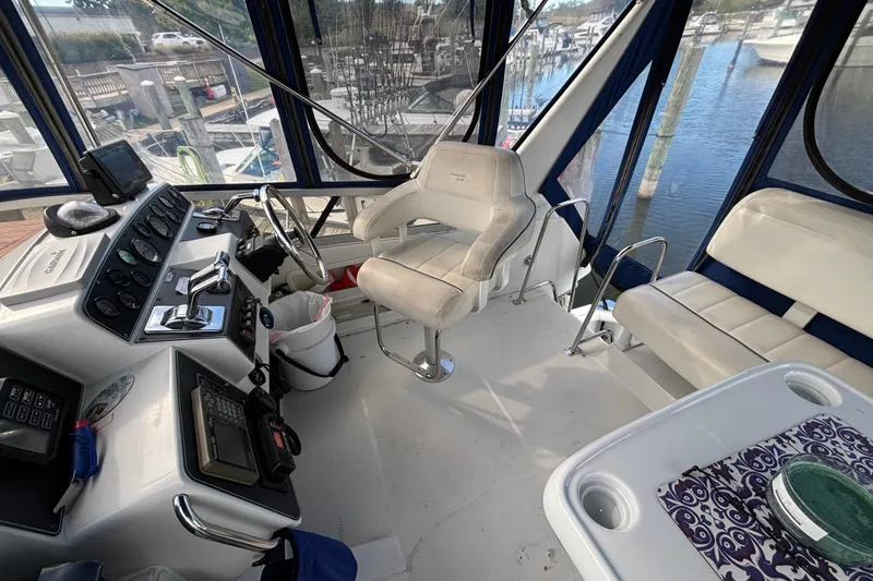Slide: The Image of Interior of a 1993 Carver 350 Voyager boat with helm and seating area. - 31