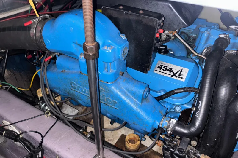 Slide: The Image of Engine of a 1993 Carver 350 Voyager boat, featuring a blue Crusader 454XL model. - 41