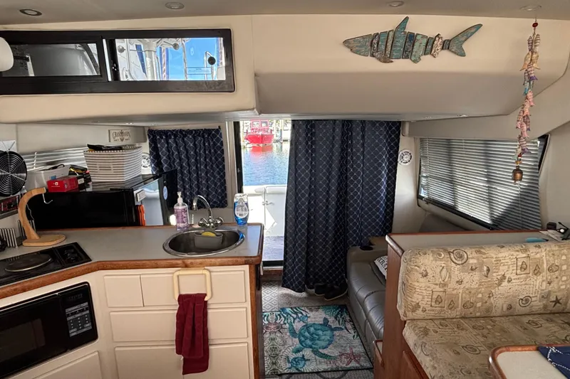 Slide: The Image of Dining area inside a 1993 Carver 350 Voyager boat with nautical-themed decor. - 17