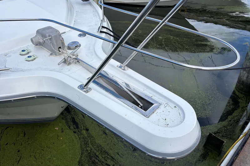 Slide: The Image of Bow of 1993 Carver 350 Voyager yacht with anchor and railing in a marina. - 38
