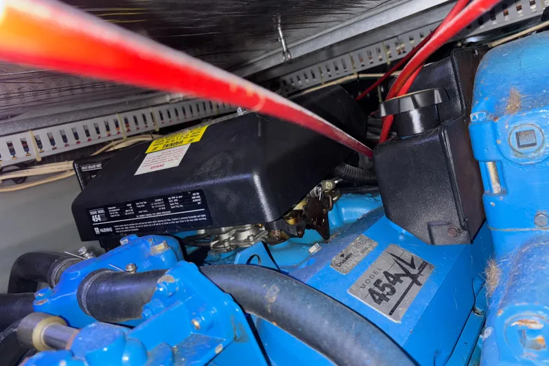 Slide: The Image of Engine compartment of a 1993 Carver 350 Voyager boat, featuring blue components and red cables. - 45
