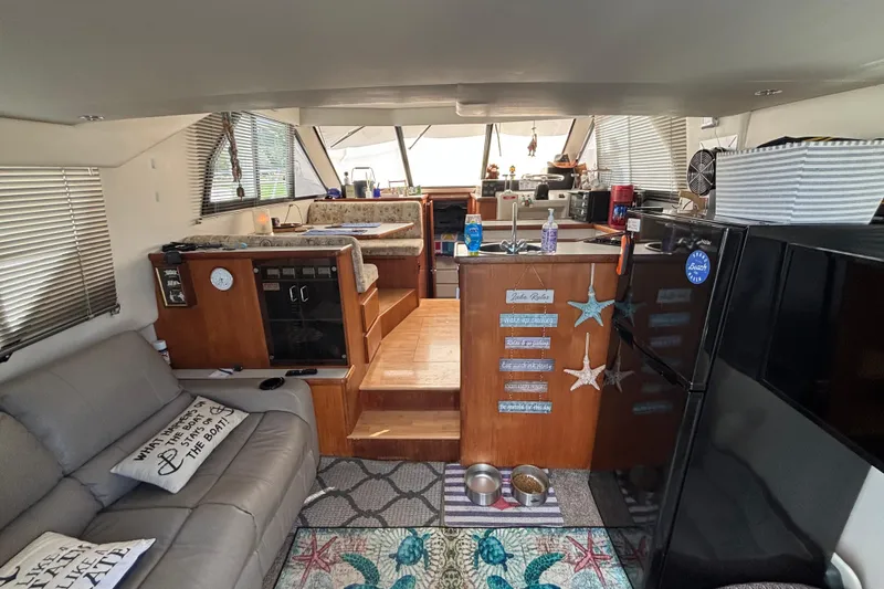 Slide: The Image of 1993 Carver 350 Voyager docked at marina with grill and flowers on wooden deck. - 6