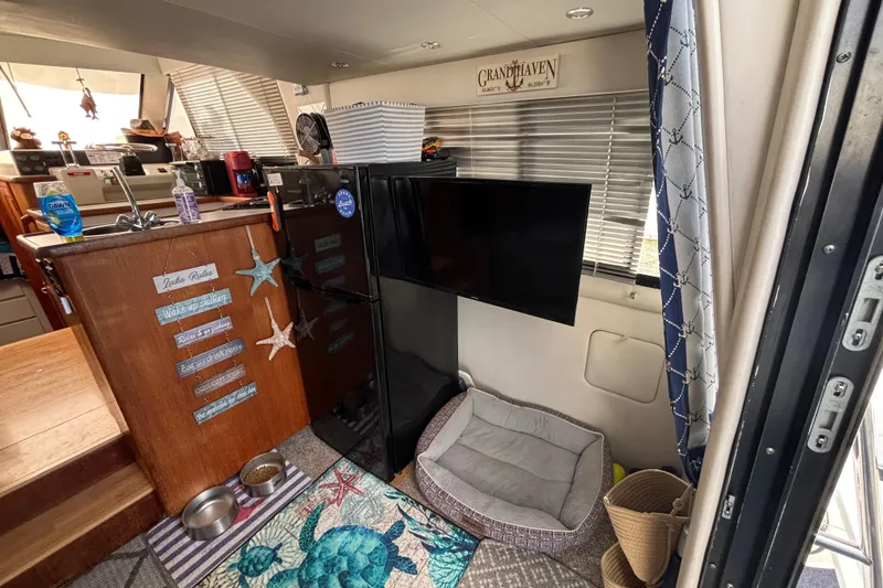 Slide: The Image of 1993 Carver 350 Voyager docked, surrounded by vibrant pink flowers. - 8