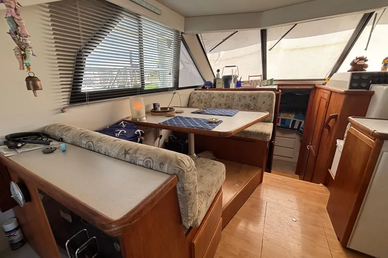 Slide: The Image of 1993 Carver 350 Voyager docked at a marina with other boats under a clear blue sky. - 9