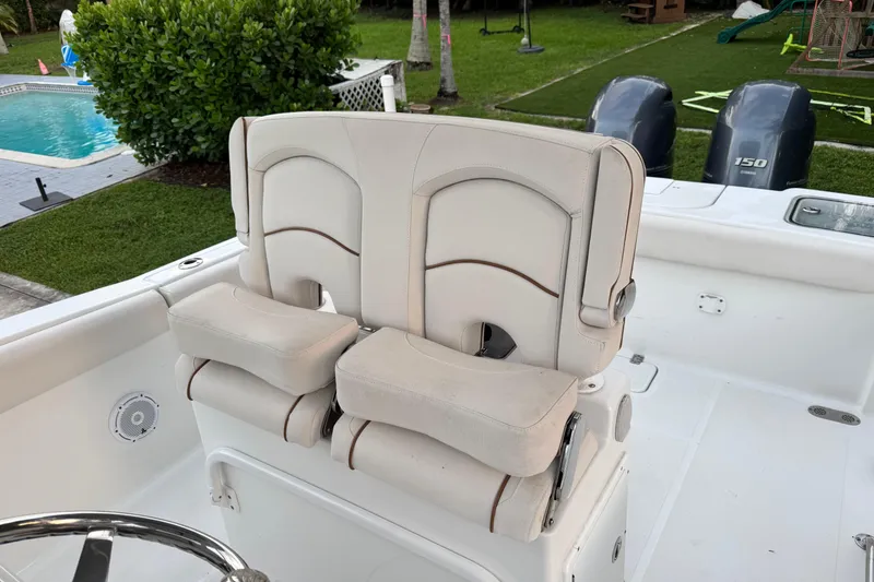 Slide: The Image of 2021 Sea Hunt Gamefish 25 boat with dual seats and twin outboard motors. - 13