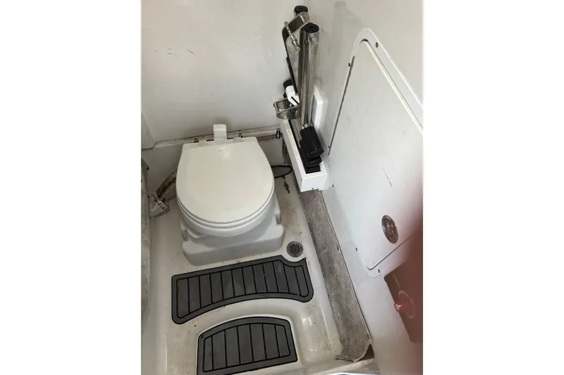 Slide: The Image of 2021 Sea Hunt Gamefish 25 boat interior with toilet and storage compartment. - 16