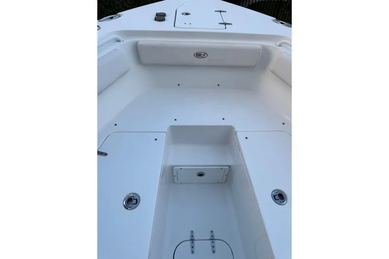 Slide: The Image of 2021 Sea Hunt Gamefish 25 boat interior, featuring spacious white deck and storage compartments. - 4