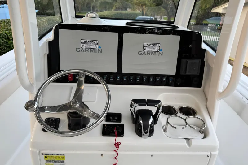 Slide: The Image of 2021 Sea Hunt Gamefish 25 helm with Garmin displays and steering wheel. - 5