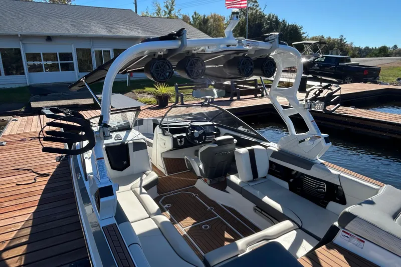 Slide: The Image of 2017 Nautique Super Air Nautique G23 boat docked, featuring sleek interior and advanced sound system. - 6