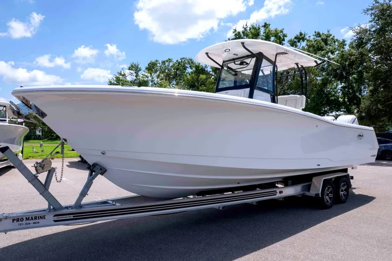 The Image of 2026 Sea Hunt Gamefish 30 Coffin Box boat on trailer under clear sky. - 0