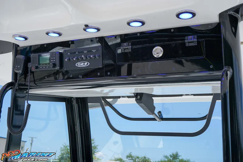 Slide: The Image of 2026 Sea Hunt Gamefish 30 Coffin Box dashboard with electronic controls and blue LED lights. - 12