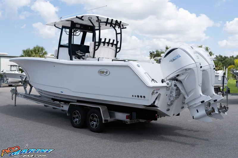 Slide: The Image of 2026 Sea Hunt Gamefish 30 Coffin Box boat on trailer, featuring dual Yamaha engines. - 2
