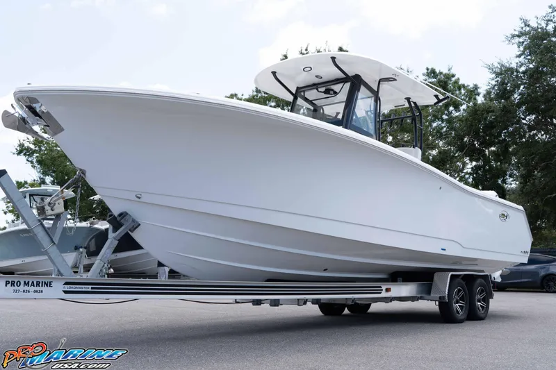 Slide: The Image of 2026 Sea Hunt Gamefish 30 Coffin Box boat on trailer, displayed outdoors. - 27