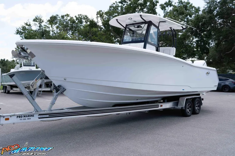 Slide: The Image of 2026 Sea Hunt Gamefish 30 Coffin Box boat on trailer, parked outdoors. - 28