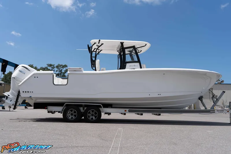 Slide: The Image of 2026 Sea Hunt Gamefish 30 Coffin Box boat on trailer under clear blue sky. - 3
