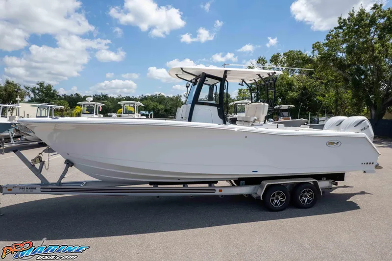 Slide: The Image of 2026 Sea Hunt Gamefish 30 Coffin Box boat on trailer, sunny day, outdoor display. - 31
