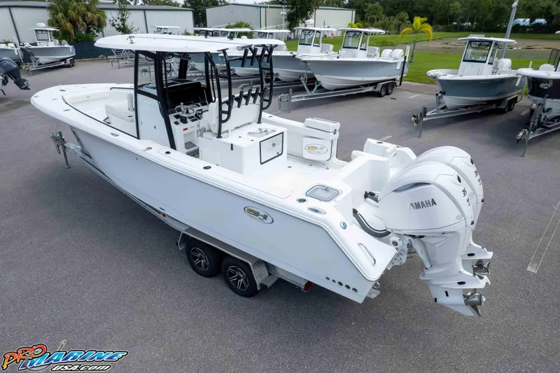Slide: The Image of 2026 Sea Hunt Gamefish 30 Coffin Box boat with dual Yamaha engines, parked on trailer. - 32
