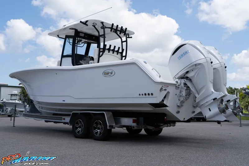 Slide: The Image of 2026 Sea Hunt Gamefish 30 Coffin Box boat on trailer, featuring dual Yamaha engines. - 33