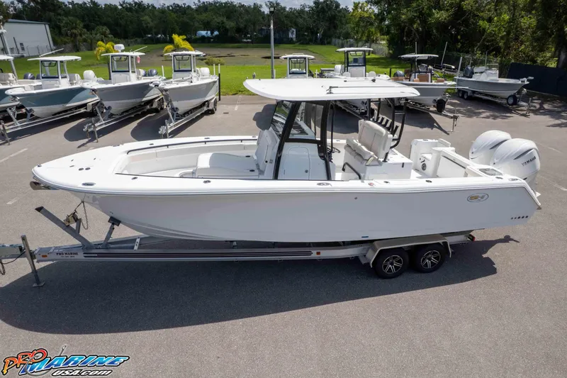 Slide: The Image of 2026 Sea Hunt Gamefish 30 Coffin Box boat on trailer in marina setting. - 34