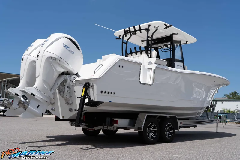 Slide: The Image of 2026 Sea Hunt Gamefish 30 Coffin Box boat on trailer, featuring dual Yamaha engines. - 39