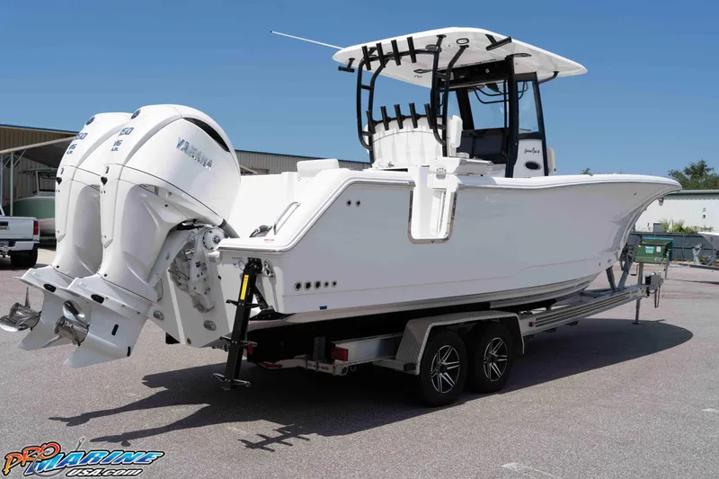 Slide: The Image of 2026 Sea Hunt Gamefish 30 Coffin Box boat on trailer, featuring twin Yamaha engines. - 41