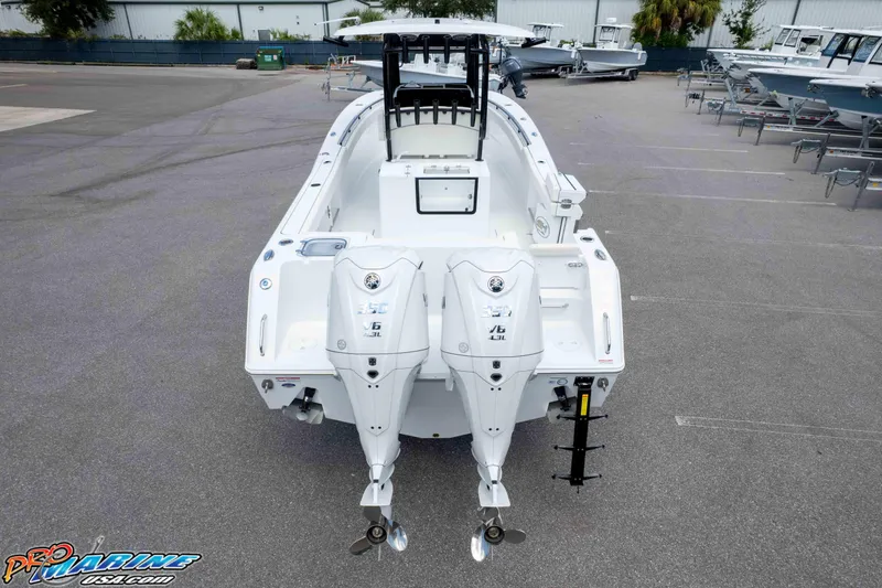 Slide: The Image of 2026 Sea Hunt Gamefish 30 Coffin Box boat with dual outboard engines, parked in a marina. - 44