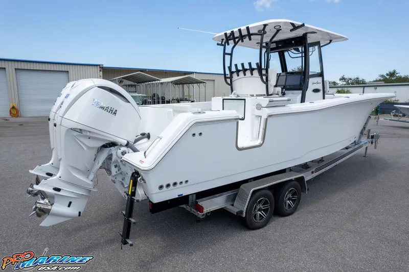 Slide: The Image of 2026 Sea Hunt Gamefish 30 Coffin Box boat on trailer, featuring dual Yamaha engines. - 47