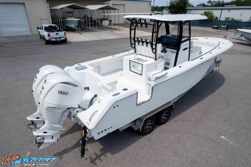 Slide: The Image of 2026 Sea Hunt Gamefish 30 Coffin Box boat with dual Yamaha engines on trailer. - 49