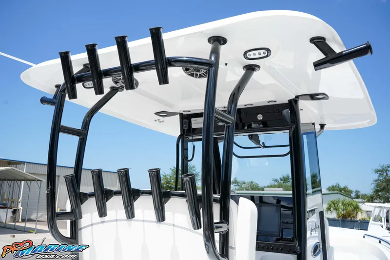 Slide: The Image of 2026 Sea Hunt Gamefish 30 Coffin Box boat with rod holders and T-top under clear sky. - 9