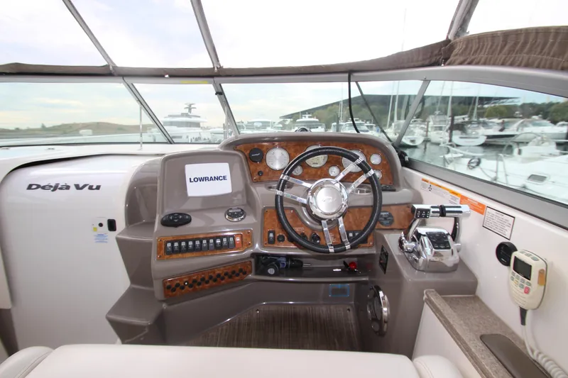 Slide: The Image of 2008 Rinker 330 Express Cruiser helm with steering wheel and navigation equipment. - 15