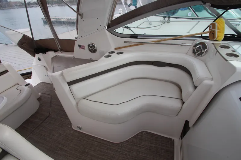 Slide: The Image of 2008 Rinker 330 Express Cruiser interior with white seating and dashboard details. - 18