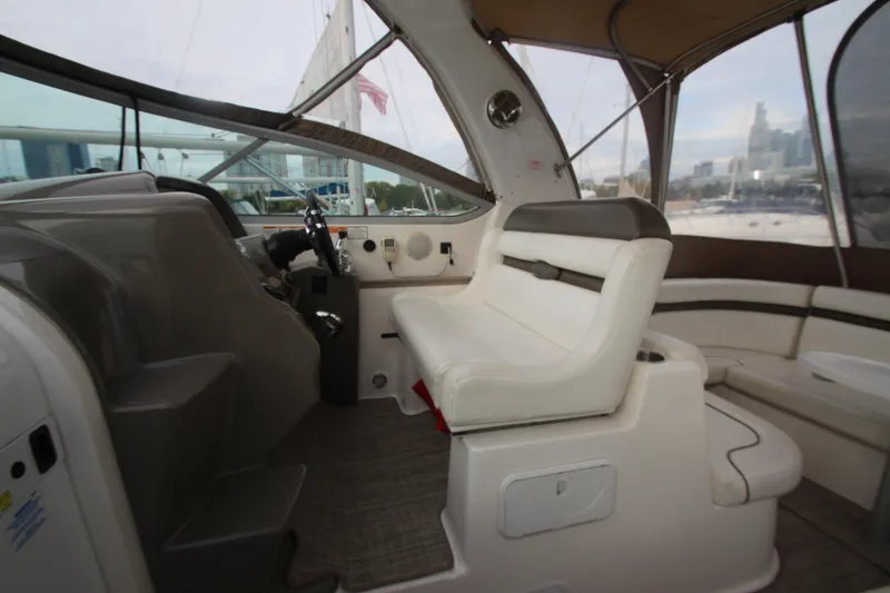 Slide: The Image of 2008 Rinker 330 Express Cruiser interior with helm and seating area. - 19