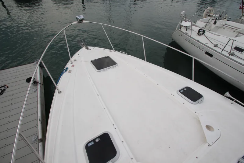 Slide: The Image of 2008 Rinker 330 Express Cruiser docked at marina, top deck view. - 2