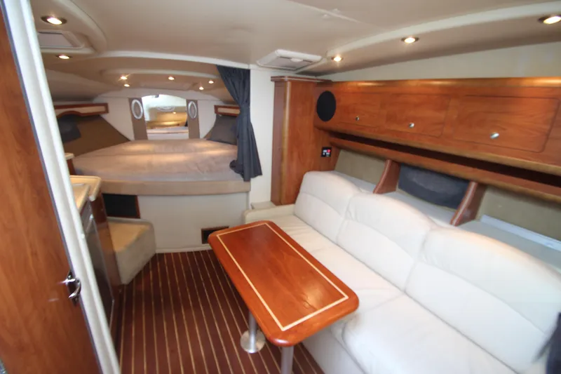 Slide: The Image of 2008 Rinker 330 Express Cruiser interior with cozy seating and elegant wood finishes. - 21