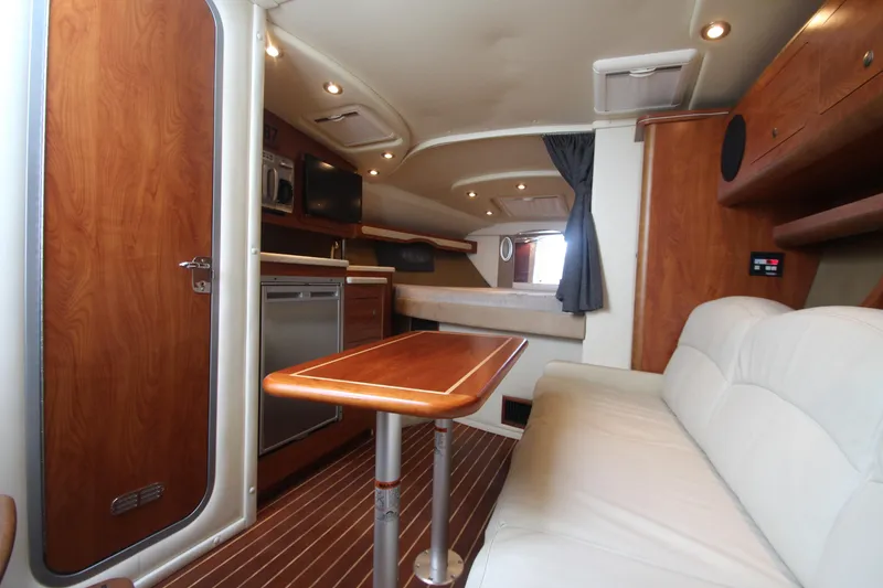Slide: The Image of 2008 Rinker 330 Express Cruiser interior with wood finishes and modern amenities. - 23