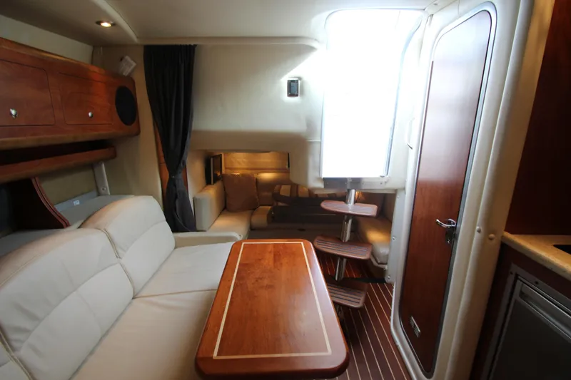 Slide: The Image of 2008 Rinker 330 Express Cruiser interior with wood accents and comfortable seating. - 28
